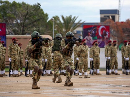 Libyan military graduates loyal to the UN-recognised Government of National Accord (GNA) perform manoeuvers during a parade marking their graduation, a result of a military training agreement with Turkey, at the Omar Mukhtar camp in the city of Tajoura, southeast of the capital Tripoli on November 21, 2020. (Photo by …