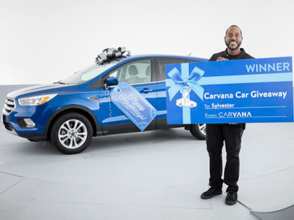Sylvester Johnson, who is from Detroit and works in Troy, was surprised with a new car from Carvana. (Photo courtesy of Carvana)