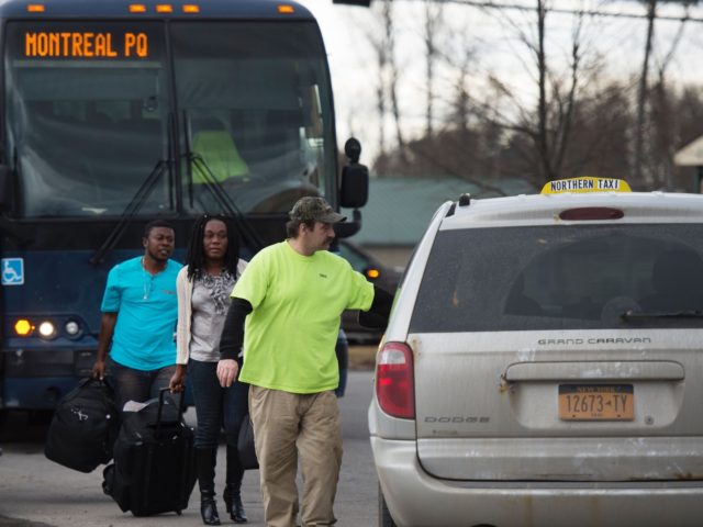 A man and a woman from Haiti transfer from a bus to a taxi February 25, 2017 in Plattsburgh, NY. The couple said they were to be dropped near the US/Canada border and would walk into Canada. / AFP / Don EMMERT (Photo credit should read DON EMMERT/AFP via Getty …