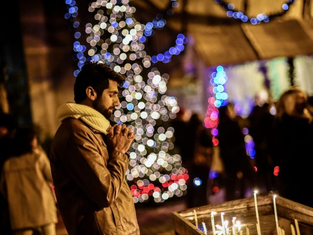 A man prays as he attends Christmas Mass at Saint Antuan Church in the Beyoglu district of