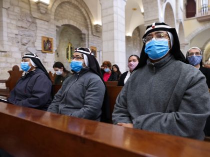 Catholic nuns attend a mass led by the Custos of the Holy Land (unseen) at the Church of the Nativity compound to ceremonially launch the beginning of the Christmas season, in Bethlehem in the Israeli-occupied West Bank,on November 28, 2020. (Photo by Emmanuel DUNAND / AFP) (Photo by EMMANUEL DUNAND/AFP …