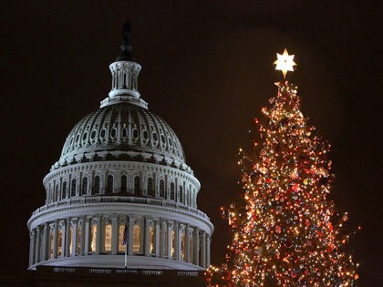 WASHINGTON - DECEMBER 9: A holiday tree is shown lit in front of the U.S. Capitol building December 9, 2004 in Washington, DC. House Speaker J. Dennis Hastert (R-Ill.) hosted the official tree lighting ceremony today. The 79-year-old red spruce weighs approximately 92 hundred pounds and is about 67 feet …