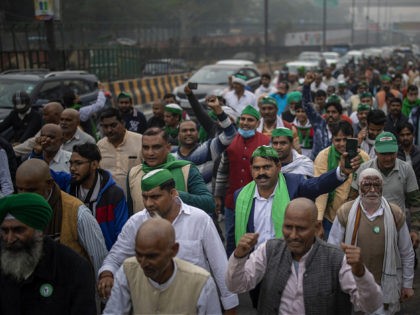 A group of protesting farmers march towards the residence of ruling Bhartiya Janata Party leader Mahesh Sharma to hand over a list of their demands during a protest against new farm in Noida on the outskirts of New Delhi, India, Saturday, Dec. 12, 2020. Indian farmers filed a petition with …