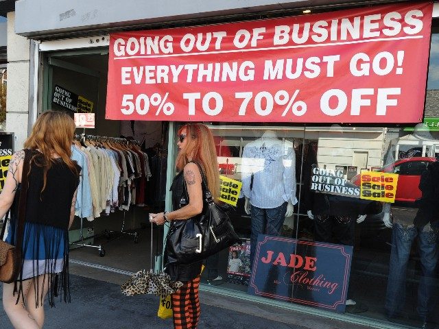 Shoppers walk past a clothing store going out of business in Los Angeles on September 28, 2010. US stocks faltered on Tuesday after a report showed US buyers' confidence dropped in September, sparking new fears over the recovery of the world's largest economy. The previous day's jittery trade continued after …