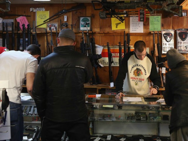 Customers shop for guns at Freddie Bear Sports sporting goods store on January 19, 2012 in Tinley Park, Illinois. (Photo by Scott Olson/Getty Images)