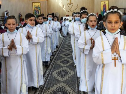 Iraqi Christian children attend their First Communion ceremony at the Mart Shmoni Syriac Orthodox church in the Ankawa suburb north of Arbil, capital of the autonomous Kurdish region of northern Iraq, on December 4, 2020. (Photo by SAFIN HAMED / AFP) (Photo by SAFIN HAMED/AFP via Getty Images)