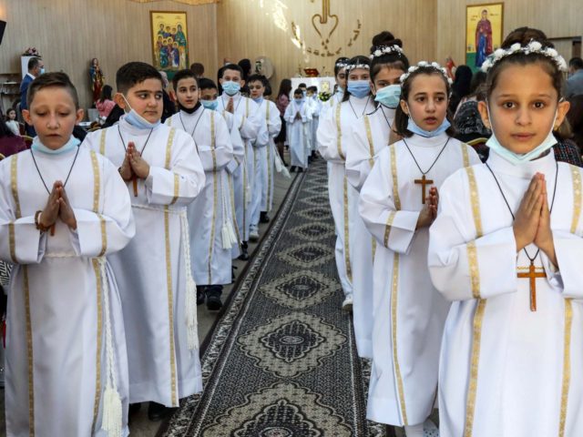 Iraqi Christian children attend their First Communion ceremony at the Mart Shmoni Syriac Orthodox church in the Ankawa suburb north of Arbil, capital of the autonomous Kurdish region of northern Iraq, on December 4, 2020. (Photo by SAFIN HAMED / AFP) (Photo by SAFIN HAMED/AFP via Getty Images)
