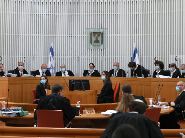 Judges and personnel of the Israeli Supreme Court wearing face masks against the coronavirus Covid-19, attend a session on May 4, 2020 at the Supreme Court in Jerusalem. - The Court tackled the vexed question of whether a political deal to form a coalition government after three inconclusive elections in …