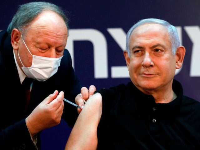 Israeli Prime Minister Benjamin Netanyahu receives a coronavirus vaccine at the Sheba Medical Center, the country's largest hospital, in Ramat Gan near the coastal city of Tel Aviv, on December 19, 2020. - Netanyahu, 71, and Israel's health minister were injected with the Pfizer-BioNTech vaccine live on TV at Sheba …
