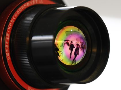 Passengers who arrived on one of the last flights from the Chinese city of Wuhan are reflected in the lens of an advanced thermo camera as they walk through a health screening station at Narita airport in Chiba prefecture, outside Tokyo, on January 23, 2020, as countries screen for anyone …