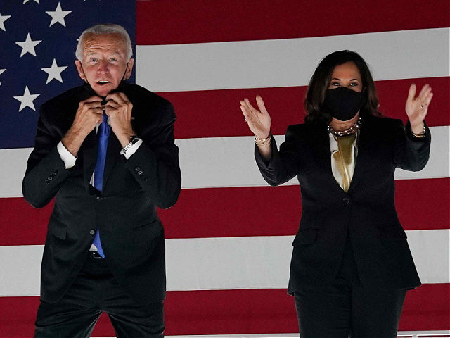 Former vice-president and Democratic presidential nominee Joe Biden briefly removes his mask as he greets supporters alond with his wife Jill Biden and Senator from California and Democratic vice presidential nominee Kamala Harris outside the Chase Center in Wilmington, Delaware, at the conclusion of the Democratic National Convention, held virtually …