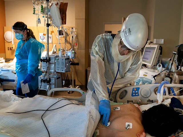 FILE - In this Nov. 19, 2020, file photo, Dr. Rafik Abdou checks on a COVID-19 patient at