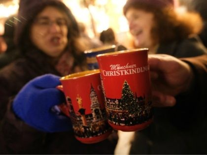 MUNICH, GERMANY - DECEMBER 13: Visitors drink mulled wine (Glühwein) at the annual Christmas at Marienplatz square on December 13, 2018 in Munich, Germany. Munich is currently in full Christmas mode with Christmas markets, decorations and shopping across the city. (Photo by Sean Gallup/Getty Images)