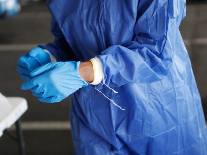 ST. PETERSBURG, FL - JULY 08: Registered nurse Gina Aubourg changes her protective gloves during testing at the COVID-19 drive-thru testing site at the Duke Energy for the Arts Mahaffey Theater on July 8, 2020 in St. Petersburg, Florida. The Pinellas County Government partnered with state and local health care …