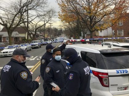 New York Police officers block off the street near the scene where a suspect was killed du