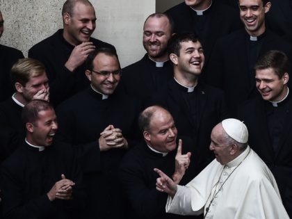 Pope Francis jokes with priests at the end of a limited public audience at the San Damaso courtyard in The Vatican on September 30, 2020 during the COVID-19 infection, caused by the novel coronavirus. (Photo by Filippo MONTEFORTE / AFP) (Photo by FILIPPO MONTEFORTE/AFP via Getty Images)