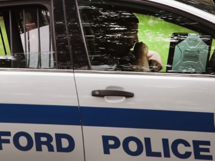 ROCKFORD, IL - JULY 12: A woman sits in the back of a squad car after she was taken into c