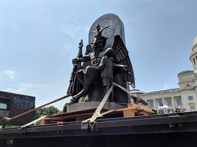 The Satanic Temple unveils its statue of Baphomet, a winged-goat creature, at a rally for the first amendment in Little Rock, Ark., Thursday, Aug. 16, 2018. The Satanic Temple wants to install the statue on Capitol grounds as a symbol for religious freedom after a monument of the Biblical Ten Commandments was installed in 2017. (AP Photo/Hannah Grabenstein)