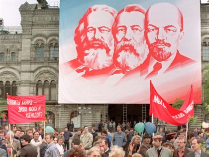 Women walk during May day official demonstration in Red Square, under portraits of Marx, Engels and Lenin, on May 01, 1990. It was the ideas of Karl Marx and Friedrich Engels that laid the conceptual foundation for the communist revolutions and regimes of the 20th century, the term Marxism-Leninism refers …