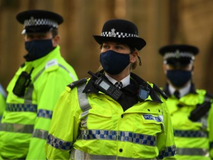 Police officers wearing protective face coverings to combat the spread of the coronavirus covid-19 oversee an anti-vax rally protest against vaccination and government restrictions designed to control or mitigate the spread of the novel coronavirus, including the wearing of masks and lockdowns, in Liverpool on November 14, 2020. (Photo by …