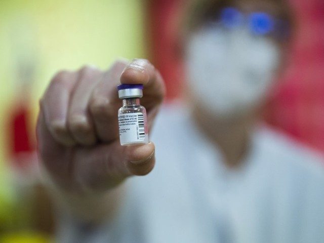 A nurse holds a vial of the COVID-19 vaccine at La Bonne Maison de Bouzanton care home in