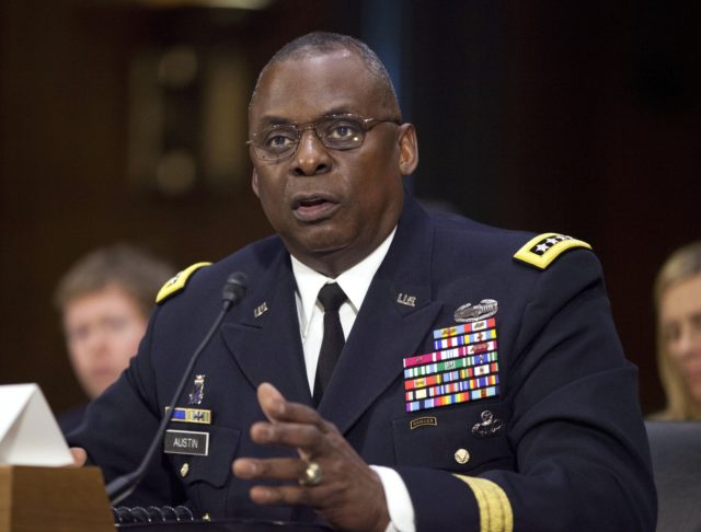 In this Sept. 16, 2015, photo, U.S. Central Command Commander Gen. Lloyd Austin III, testifies on Capitol Hill in Washington. Biden will nominate retired four-star Army general Lloyd J. Austin to be secretary of defense. That's according to three people familiar with the decision who spoke on condition of anonymity …