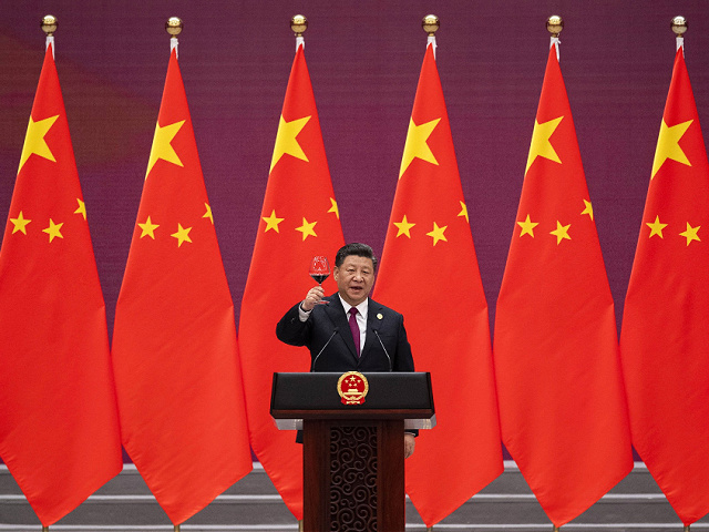 Chinese President Xi Jinping raises his glass and proposes a toast during the welcome banquet for visiting leaders attending the Belt and Road Forum at the Great Hall of the People, Friday, April 26, 2019. (Nicolas Asfouri/Pool Photo via AP)