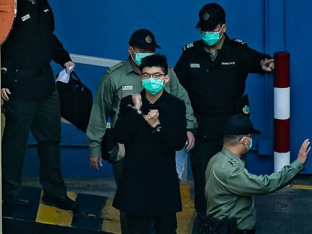 HONG KONG, CHINA - DECEMBER 18: Pro-democracy activist Joshua Wong prepares to board a Cor