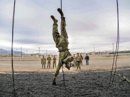 An air assault instructor at Fort Bliss rappels upside down and stops only a few feet from the ground, Oct. 15 at Fort Bliss, Texas. (U.S. Army photo by Sgt. Brandon M. Banzhaf, Theater Public Affairs Support Element)