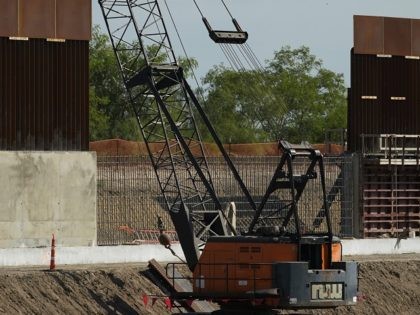 Construction workers build a border wall in Mission, Texas, Monday, Nov. 16, 2020. President-elect Joe Biden will face immediate pressure to fulfill his pledge to stop border wall construction. But he will confront a series of tough choices left behind by President Donald Trump, who's ramped up construction in his …