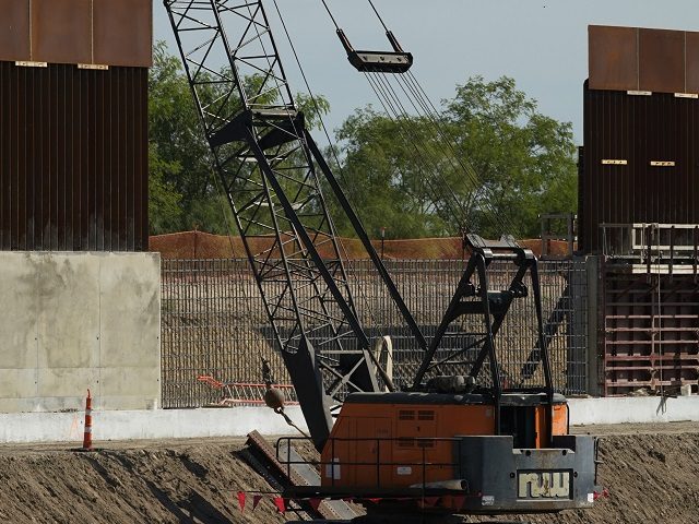 Construction workers build a border wall in Mission, Texas, Monday, Nov. 16, 2020. Preside