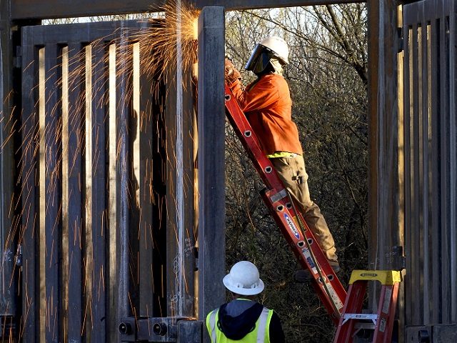 Crews construct a section of border wall in San Bernardino National Wildlife Refuge, Tuesday, Dec. 8, 2020, in Douglas, Ariz. Construction of the border wall, mostly in government owned wildlife refuges and Indigenous territory, has led to environmental damage and the scarring of unique desert and mountain landscapes that conservationists …