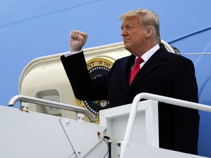 President Donald Trump gestures as he steps off Air Force One upon arrival at Valley Inter