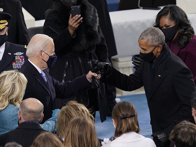 President-elect Joe Biden his greeted by former President Barrack Obama as he arrives for the 59th Presidential Inauguration at the U.S. Capitol in Washington, Wednesday, Jan. 20, 2021. (AP Photo/Carolyn Kaster)