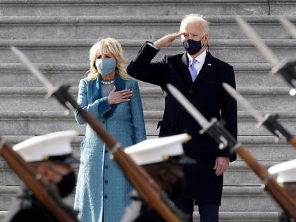 President Joe Biden and his wife Jill Biden watch a military pass in review ceremony on th