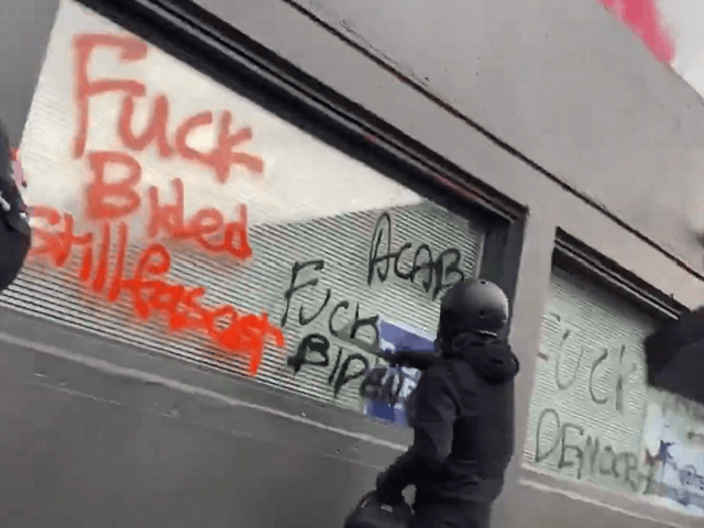 Antifa vandalizes the Portland Democratic Party offices on the day of President Joe Biden's inauguration. (Twitter Video Screenshot/Julio Rosas, Townhall.com)