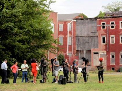 Journalists wait for a press conference with Housing and Urban Development Secretary Ben Carson to begin on a grass lot adjacent to the Morning Star Baptist Church of Christ, Wednesday, July 31, 2019, in Baltimore. Carson toured the nearby Hollins House, which has 130 one-bedroom units, and said the housing …