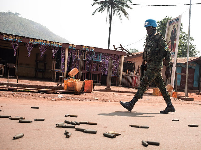 A United Nations Multidimensional Integrated Stabilization Mission in the Central African Republic (MINUSCA) soldier patrols in PK12, in front of a bar where it says "Ambiance of PK12", in front of heavy weapon casings, 12 kilometres from downtown Bangui, on January 13, 2021 where fighting raged against the rebels of …