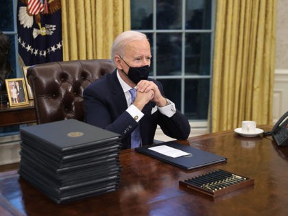 WASHINGTON, DC - JANUARY 20: U.S. President Joe Biden prepares to sign a series of executi