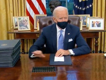 Biden Signs Mask Mandate Wearing Mask