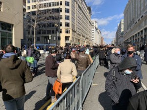 A crowd gathers on a DC street for the inauguration.