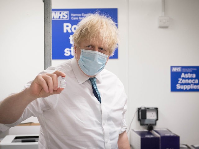 LONDON, ENGLAND - JANUARY 25: British Prime Minister Boris Johnson sees how a dose of the Oxford/Astra Zeneca Covid 19 vaccine is prepared for a mobile vaccination centre at Barnet FC's ground at The Hive, on January 25, 2021 in London, England. Government figures show that 6.3 million people across …
