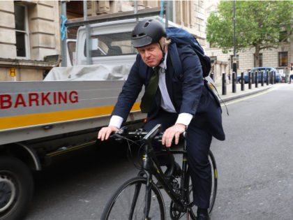 LONDON, ENGLAND - JUNE 15: Former Mayor of London Boris Johnson cycles past Portcullis Hou