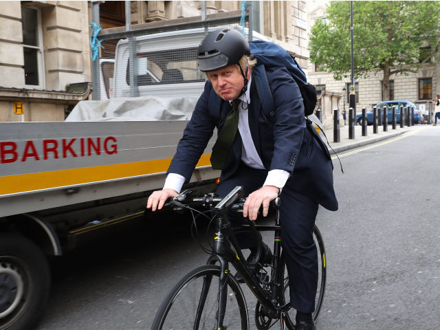 LONDON, ENGLAND - JUNE 15: Former Mayor of London Boris Johnson cycles past Portcullis House on June 15, 2016 in London, England. Johnson is part of the campaign for the United Kingdom to leave the European Union in a referendum being held on June 23, 2016. (Photo by Dan Kitwood/Getty …
