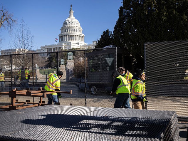 WASHINGTON, DC - JANUARY 07: Workers build a fence around the U.S. Capitol on January 07, 2021 in Washington, DC. Supporters of President Trump had stormed and ransacked the building the day before as Congress debated the a 2020 presidential election Electoral Vote Certification. (Photo by John Moore/Getty Images)
