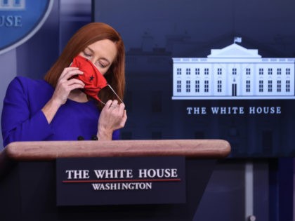 WASHINGTON, DC - JANUARY 20: White House Press Secretary Jen Psaki removes her face mask to start her first news conference of the Biden Administration in the Brady Press Briefing Room at the White House January 20, 2021 in Washington, DC. Psaki previously worked in the Obama Administration as White …