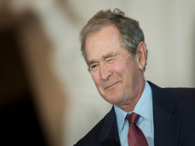 Former US President George W. Bush winks on December 3, 2015, during a dedication ceremony hosted by the US Senate at Emancipation Hall of the US Capitol Visitor Center in Washington, DC. The ceremony unveiled a bust of former US Vice President Dick Cheney, who as vice president, also served …