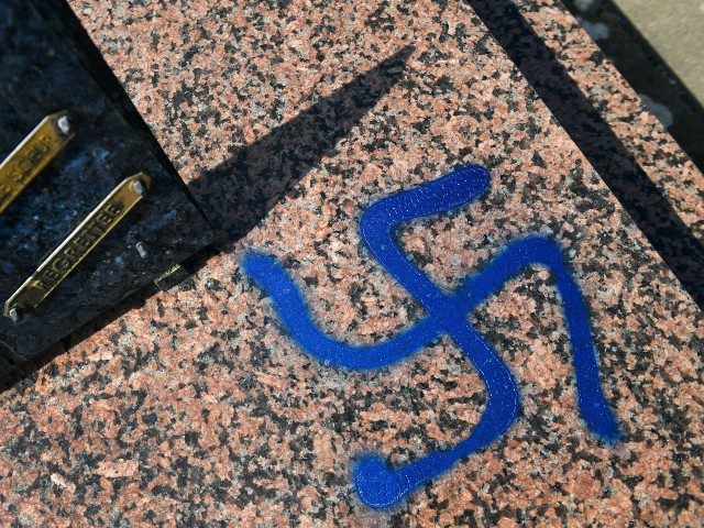 A picture taken on April 1, 2019 shows a grave vandalised with spray-painted swastikas at a cemetery in Ploermel, western France. (Photo by Fred TANNEAU / AFP) (Photo credit should read FRED TANNEAU/AFP via Getty Images)