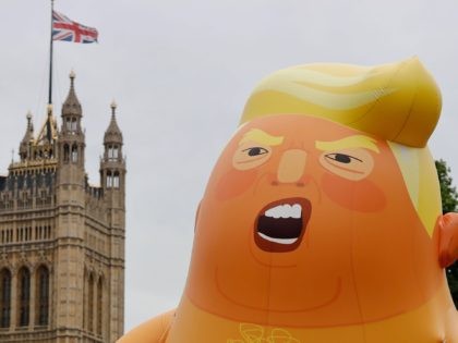 TOPSHOT - A giant balloon depicting US President Donald Trump as an orange baby floats abo