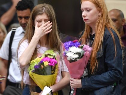 MANCHESTER, ENGLAND - MAY 22: A woman shows emotion during a two minute silence is observe